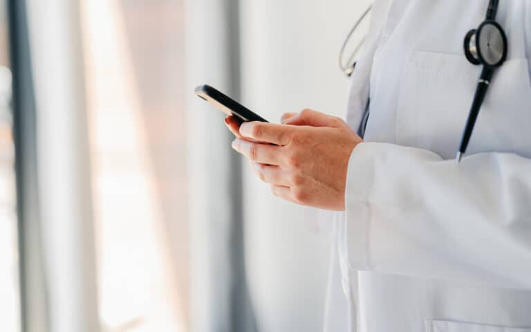 doctor, phone and 5g network with medical worker typing and texting on social media, contact us website or mobile app. healthcare or medical help while answering a question during online consultation